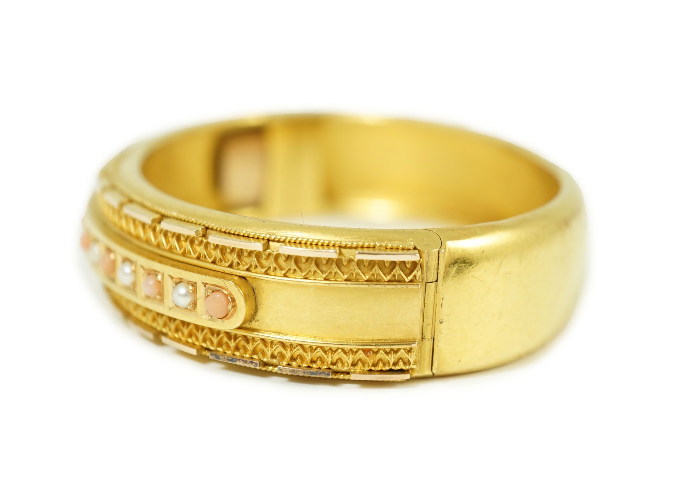 A late Victorian 15ct gold coral bead and seed pearl set part cannetile work hinged bangle